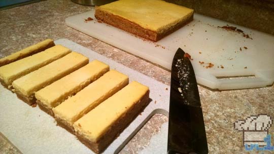 The Peanut Cheese Bars have been sliced and are waiting to be coated in chocolate before eating.