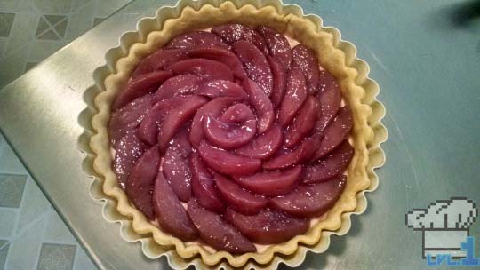 The poached peaches are assembled into a fan design for the top of the tart.