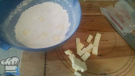 A bowl of flour with cold butter cut into cubes for the tart dough preparation.