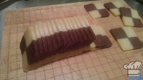 Checkerboard cookies sliced into thin cookies and ready to be baked.