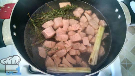 A pot of simmering salmon, thyme and lemongrass to make a broth for Simple Soup recipe.