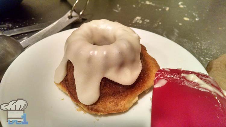 Golden brown baked sweetroll popovers covered in a light velvety blanket of white icing, just like the video game pixel sprite.