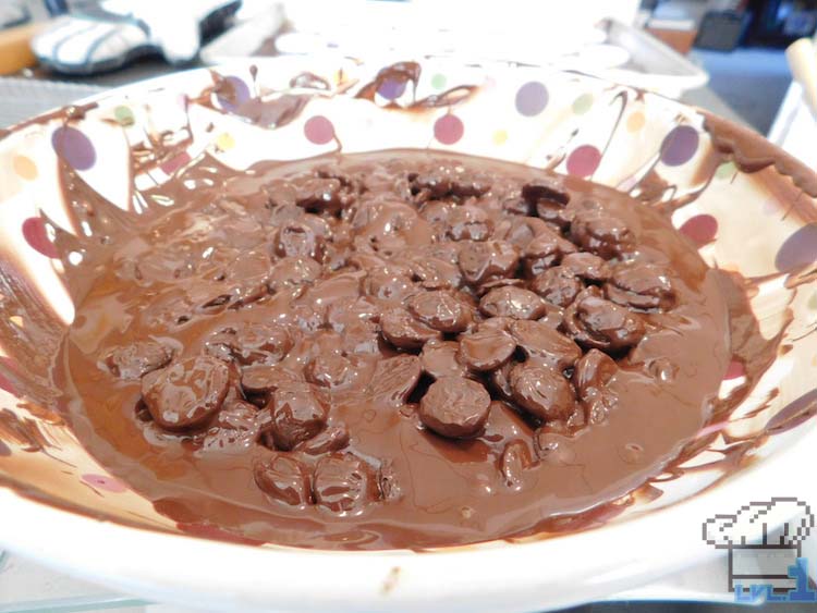 Chocolate chips melting in a bowl to fold into the ganache for the chocolate burger patties.