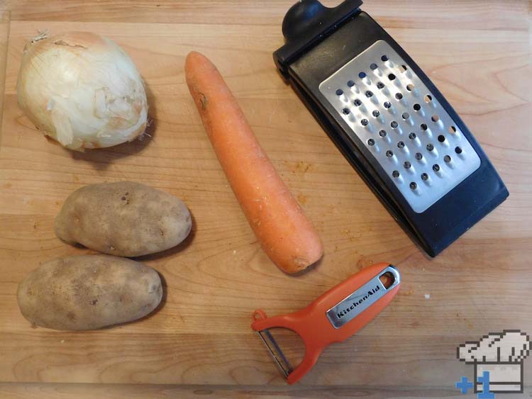 Onion, carrot and potatoes ingredients ready to be grated on a box grater for the Superspicy Curry recipe from Kirby's Dream Land game series.