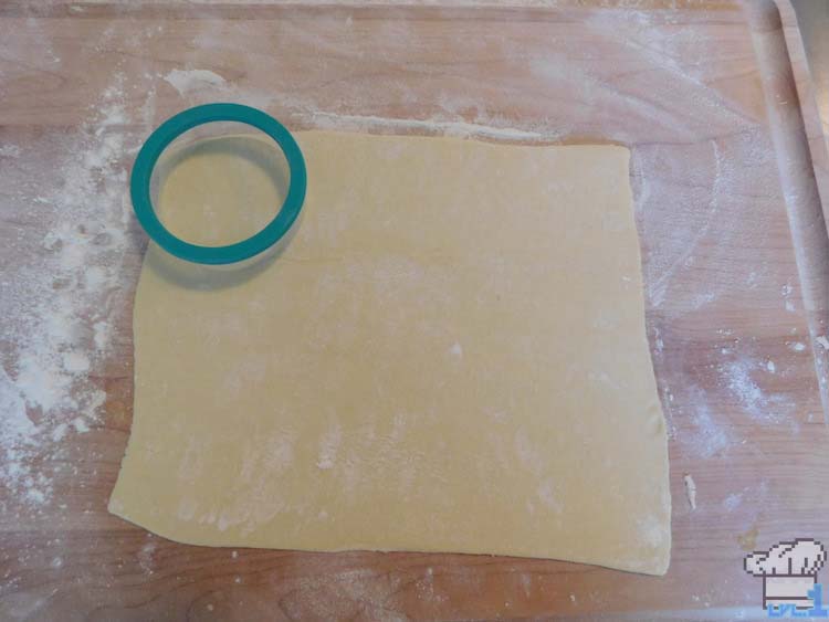 Puff pastry dough thawed out and flattened one sheet on floured counter top waiting to be cut with large circle cookie cutter for shape of Lumiose Galette.
