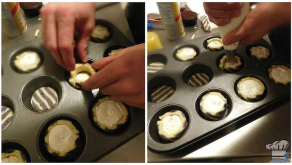 Piping the buttercream into the bases of the blueberry joconde sponge cake cups.