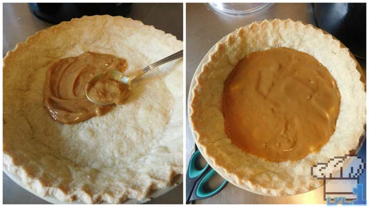 Spreading the dulce de leche on the bottom of the pie crust for the base of the cheesecake, before adding the filling.