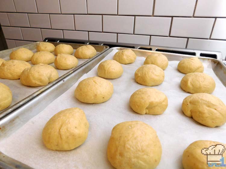 Letting the malasada doughnut dough balls rise individually before frying.