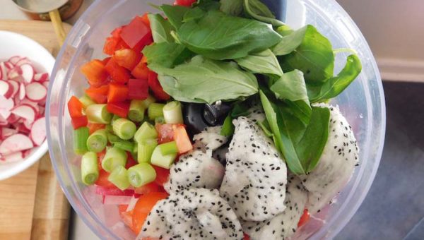 Combining all of the ingredients into the food processor for easy blending.