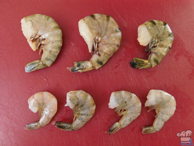 Shrimp size comparison prior to cleaning, all lain out on the cutting board in a row.